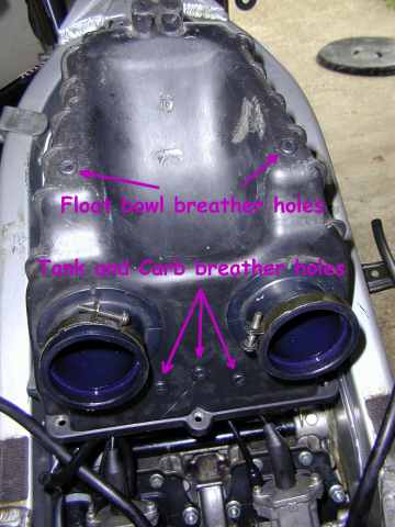 Holes in air box for breather pipes
